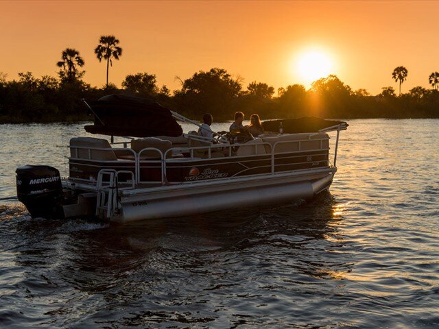 Guests on a sunset pontoon cruise on the Zambezi near Old Drift Lodge
