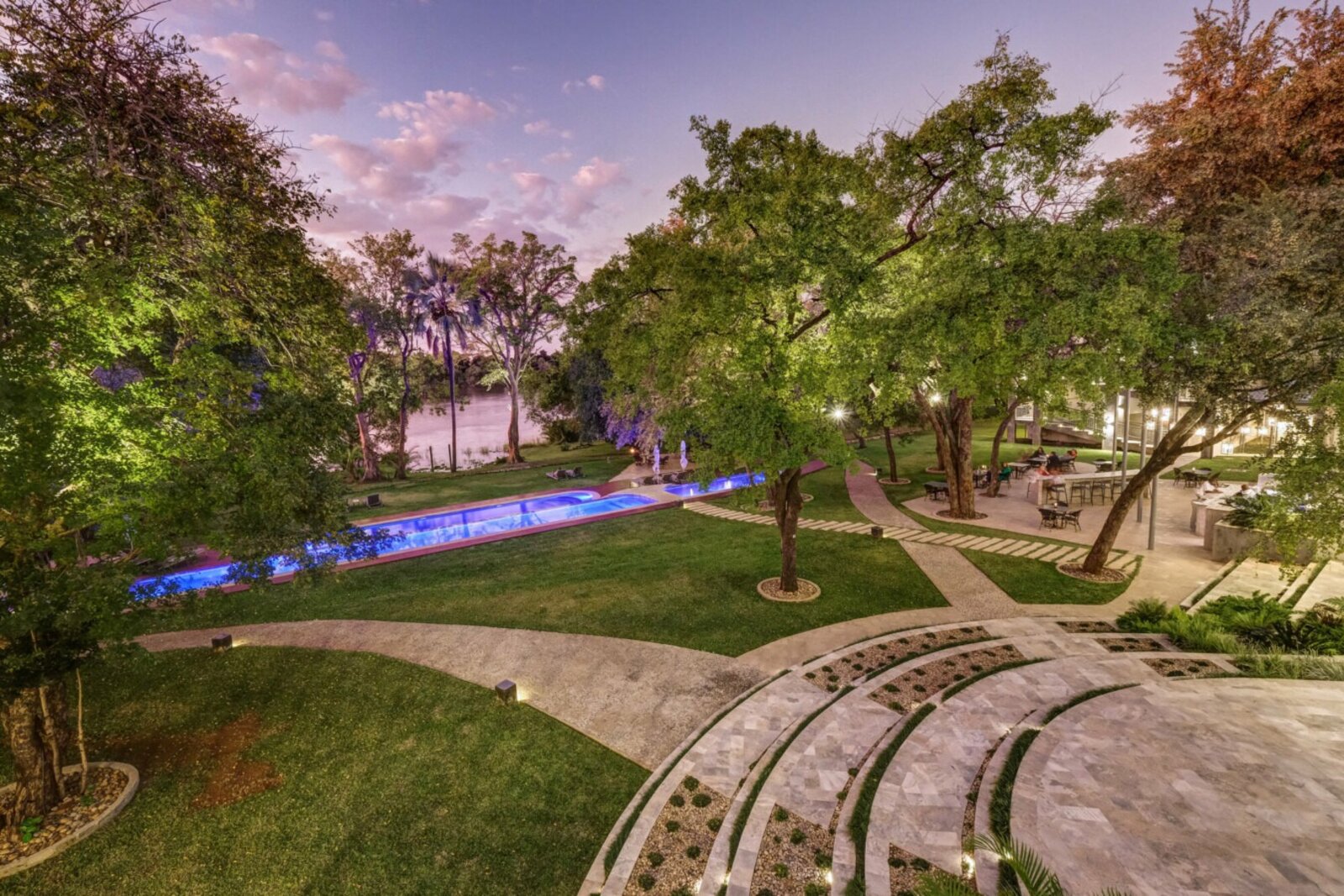 The hotel grounds at dusk running down to the Zambezi River at The Palm River Hotel