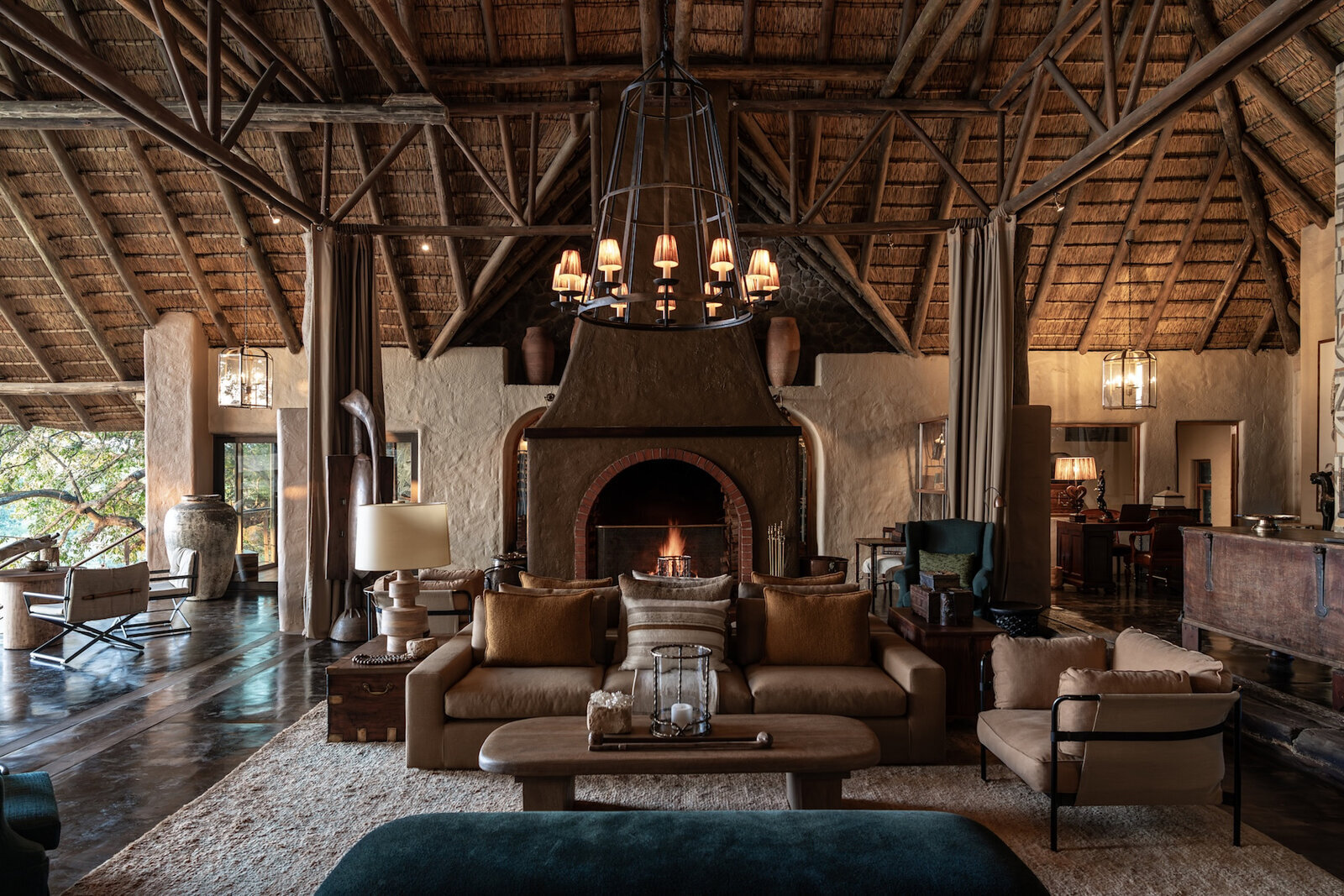 A luxury clifftop lodge overlooking the bay at Plettenberg Bay at golden hour