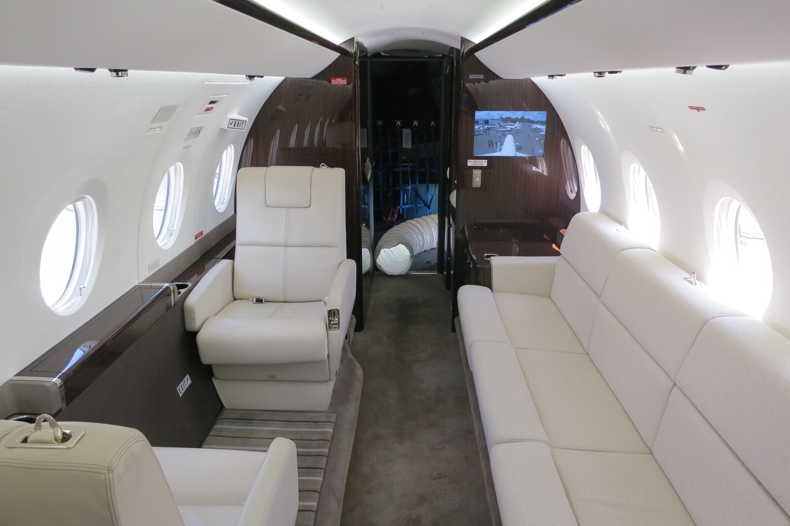 Executive private jet cabin interior with lie-flat leather seating