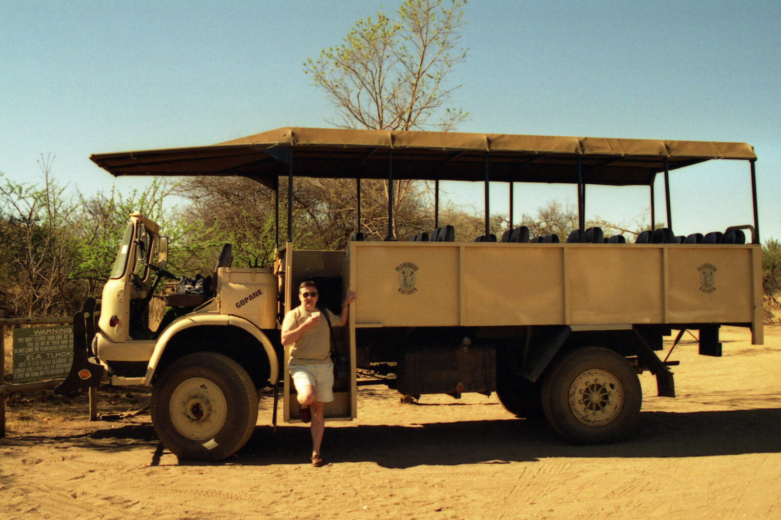 Guests in an open safari vehicle on a South Africa safari package game drive