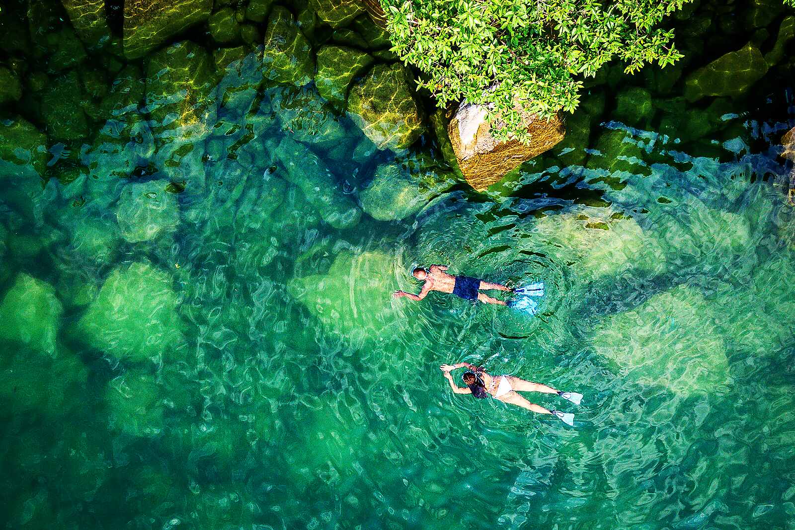 Snorkellers float over the crystal-clear shallows of Lake Malawi