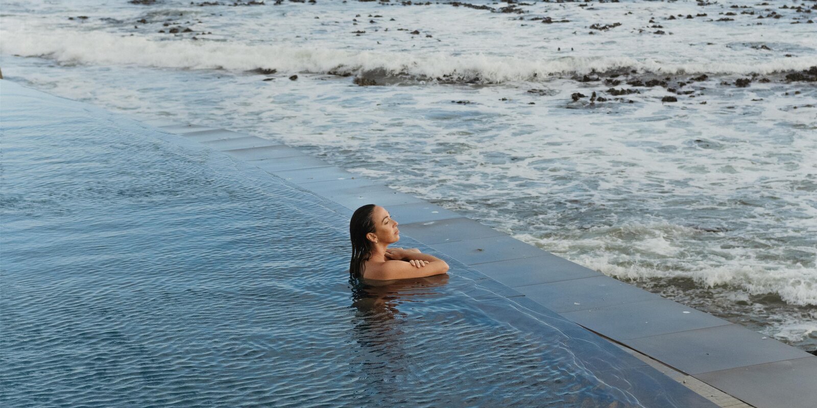The rim-flow pool at the Radisson Collection Waterfront reading out to the Atlantic, a guest in the water