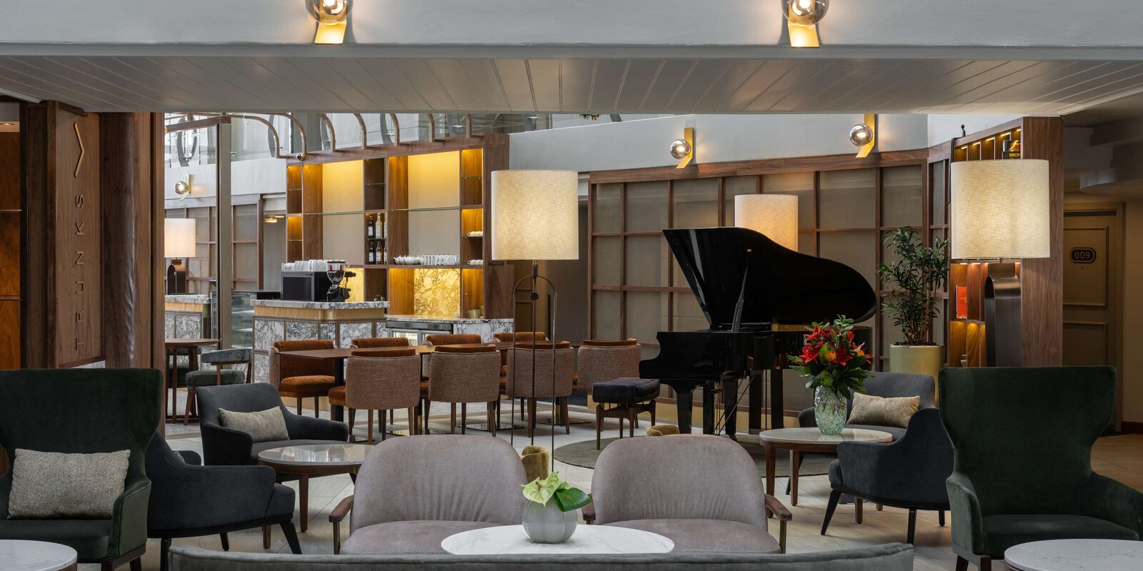 The lobby lounge and bar with a grand piano at the Radisson Collection Waterfront