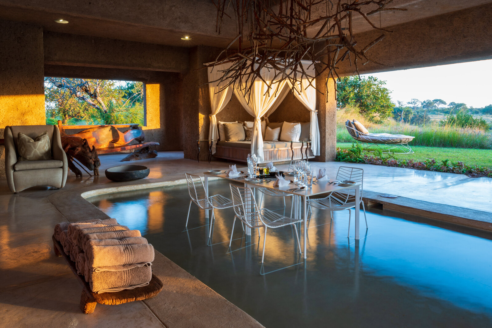The main lounge at Sabi Sabi Earth Lodge with organic design and Geoffrey Armstrong sculptures