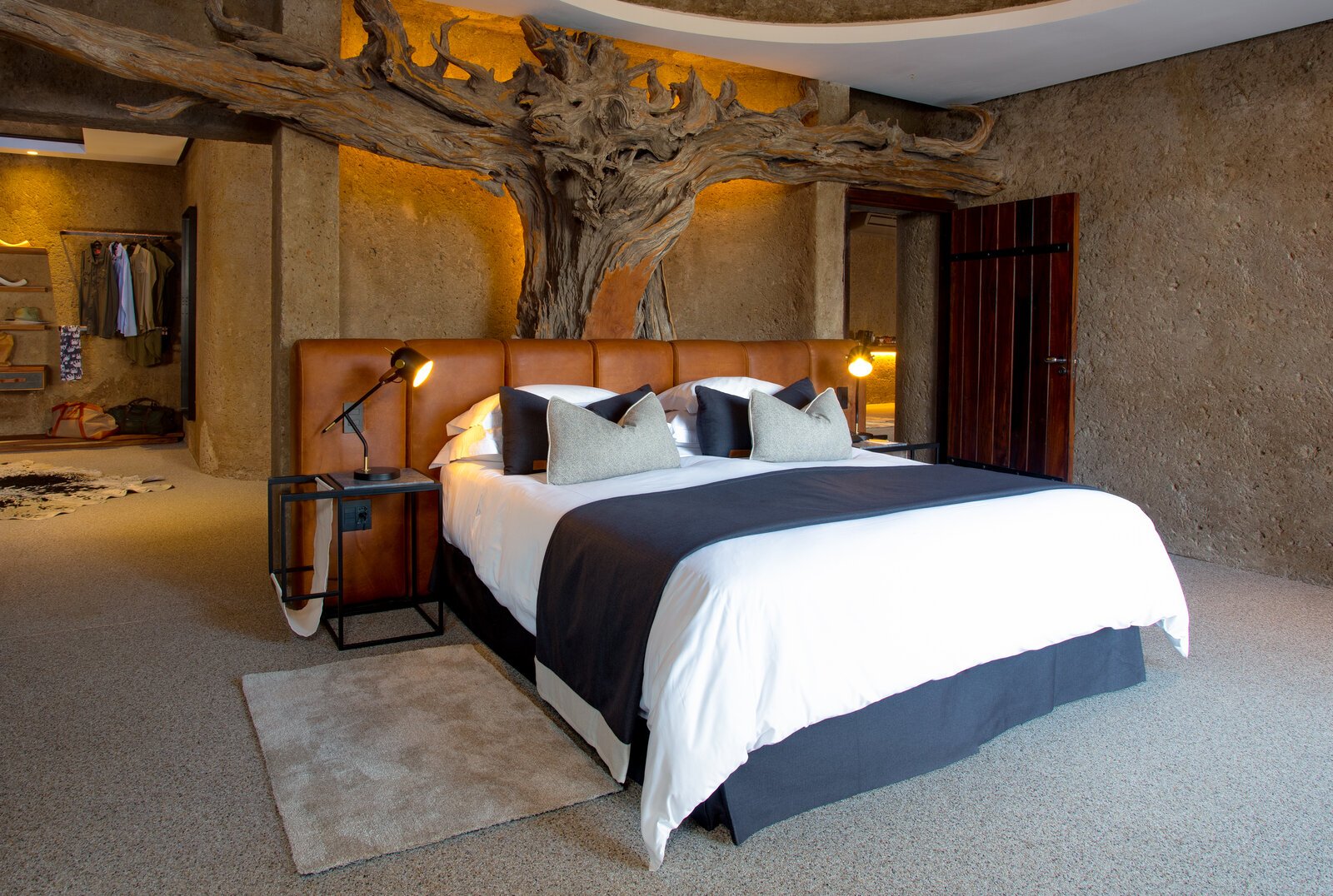 The Amber Villa bedroom at Sabi Sabi Earth Lodge with dramatic Geoffrey Armstrong tree sculpture