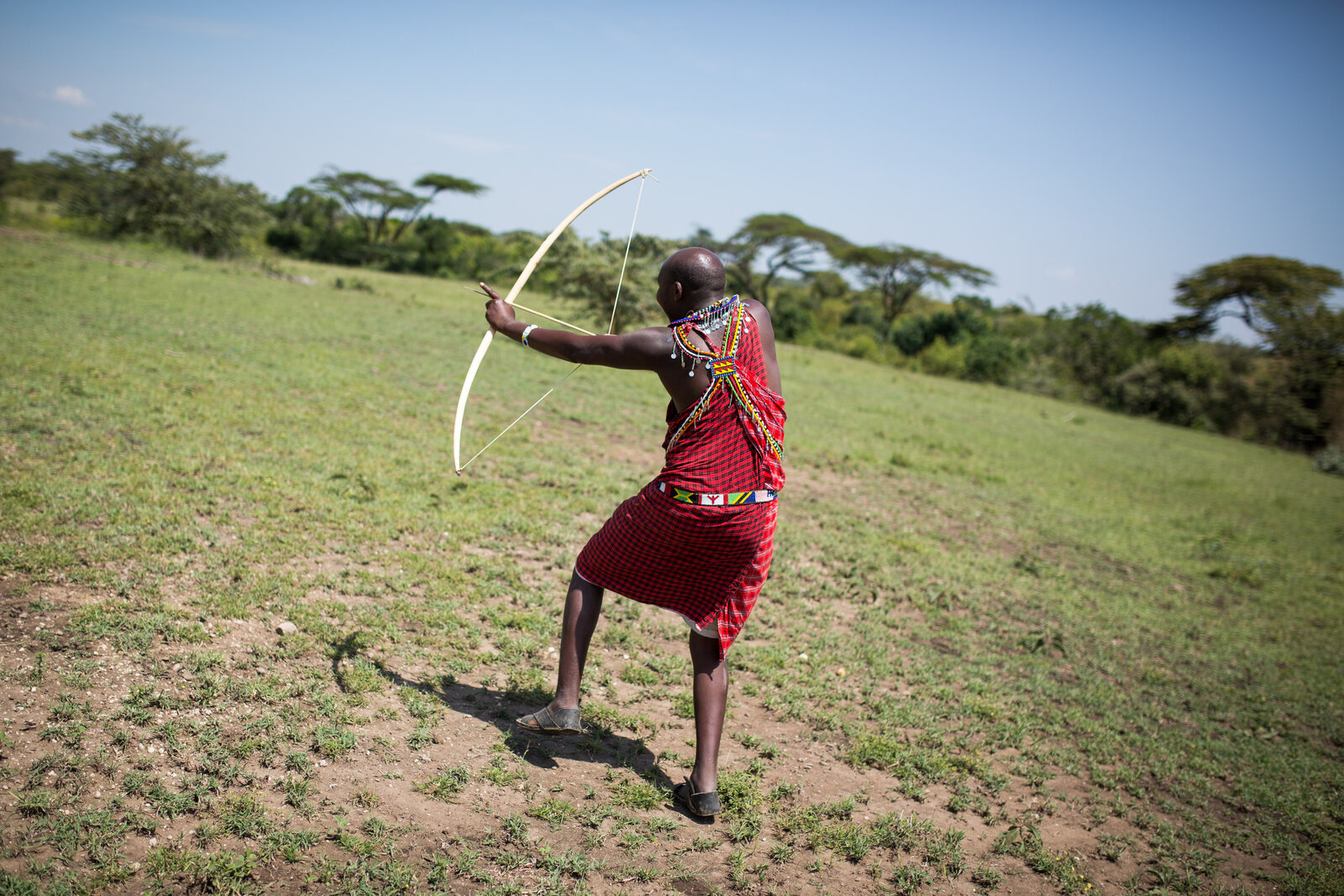 A Maasai guide in traditional dress sharing local knowledge with guests