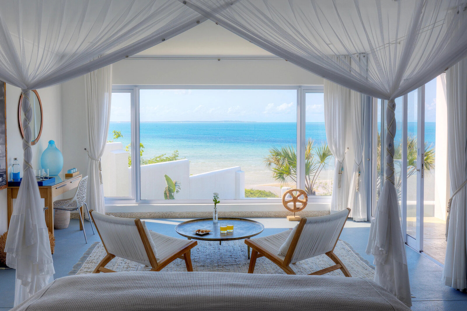 An ocean-view suite at Santorini Mozambique with arched windows framing the sea