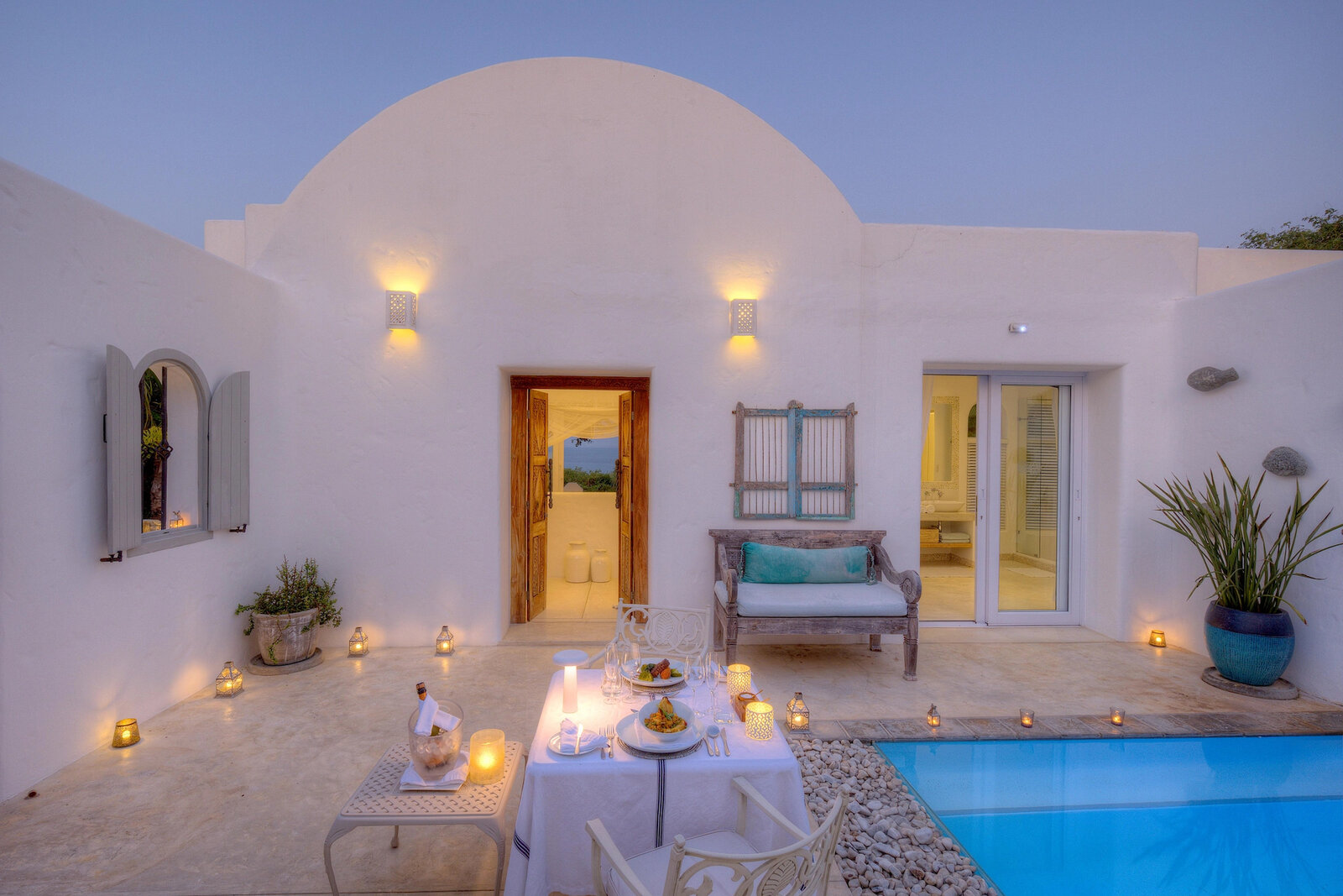 A candlelit dinner in the whitewashed courtyard at Santorini Mozambique above Vilanculos