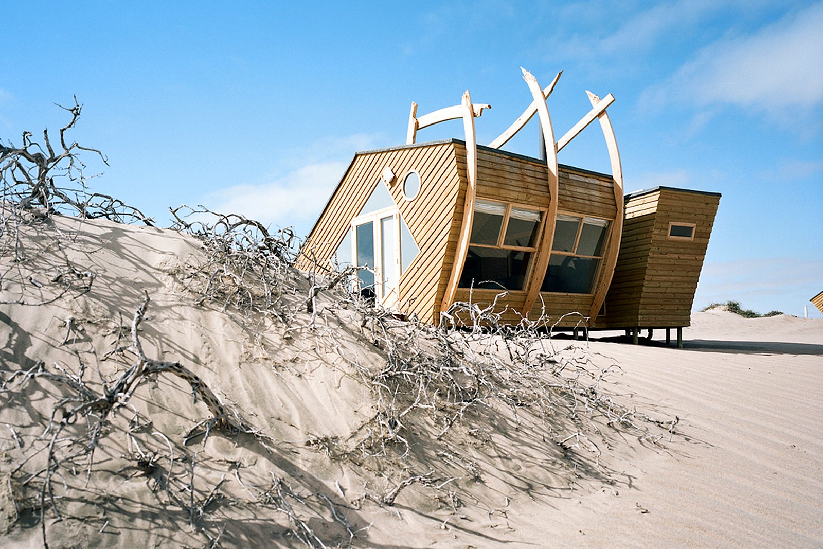 Shipwreck-shaped cabins among the dunes on the Skeleton Coast