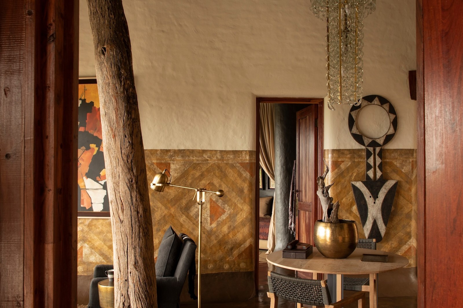 Interior of a Singita Pamushana suite with African art, timber and stone