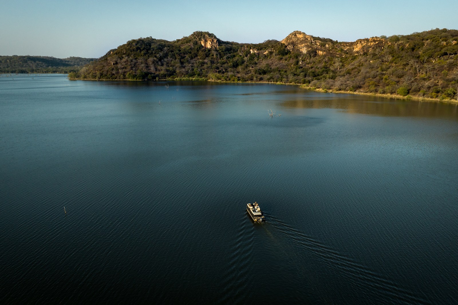 Sunset boat cruise on the Malilangwe Dam at Singita Pamushana