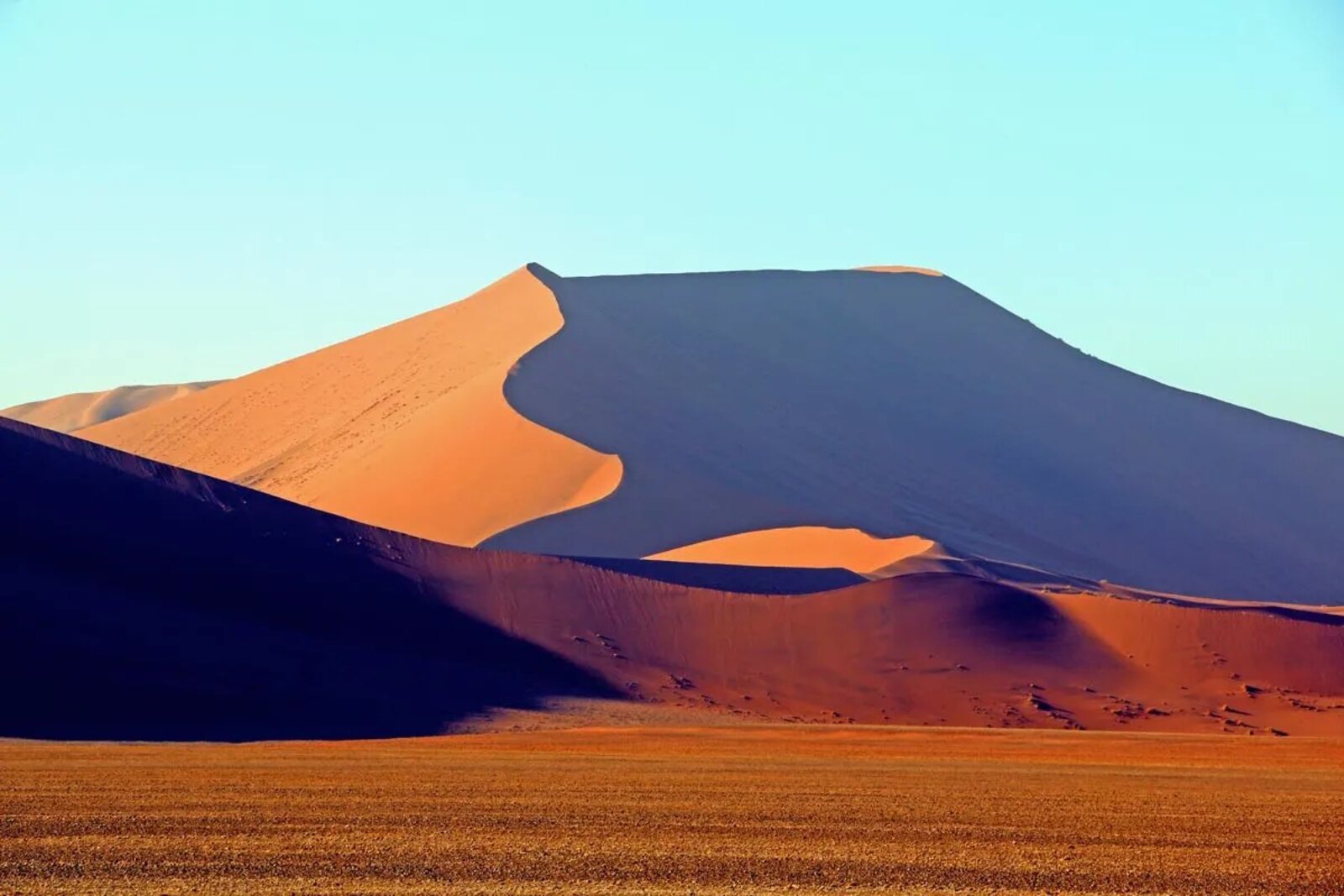 The red dunes of Sossusvlei rolling across the Namib desert