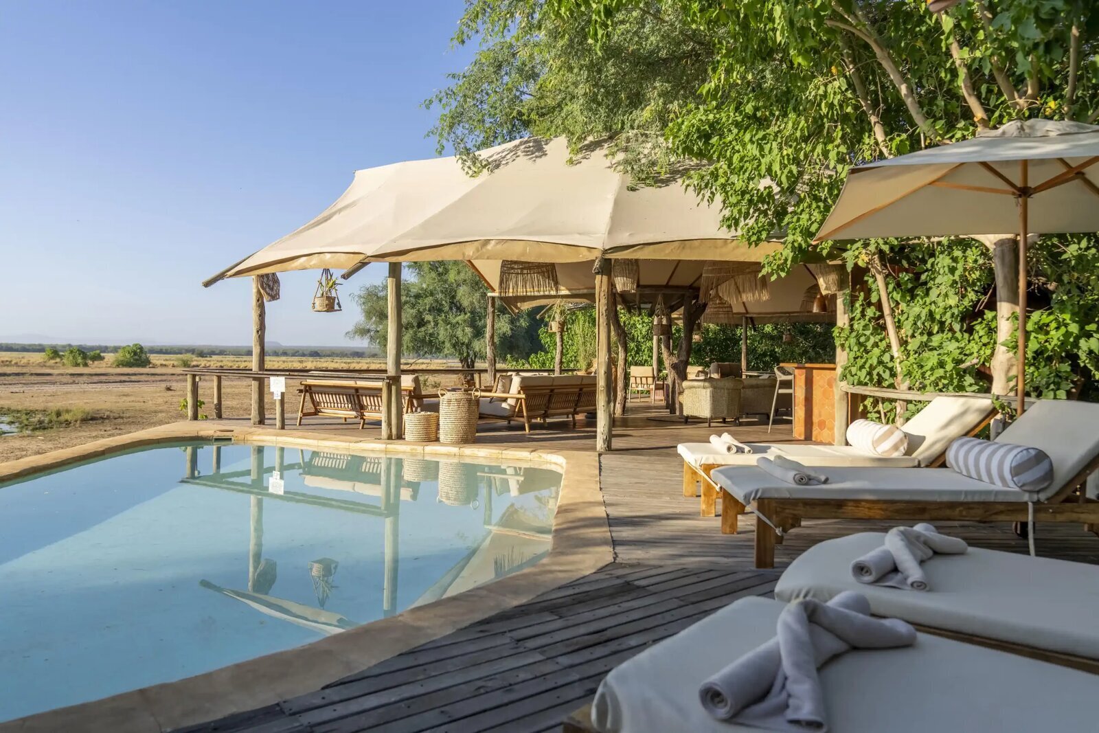 A luxury safari lodge suite with a private deck overlooking the African bush