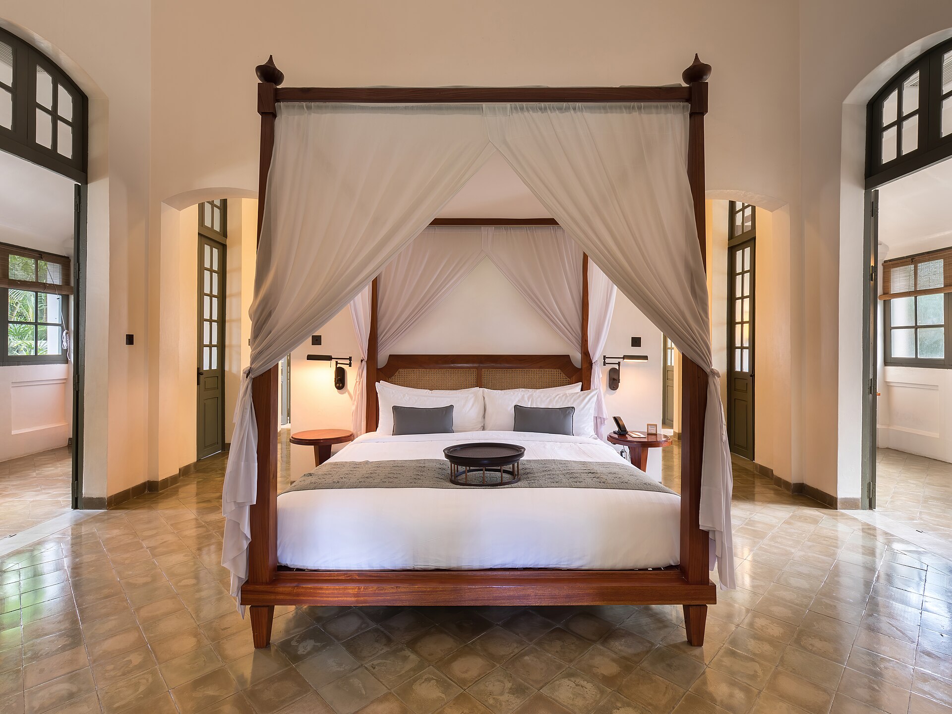 A luxury suite with a canopied bed and colonial-style furnishings at the Stanley & Livingstone Boutique Hotel
