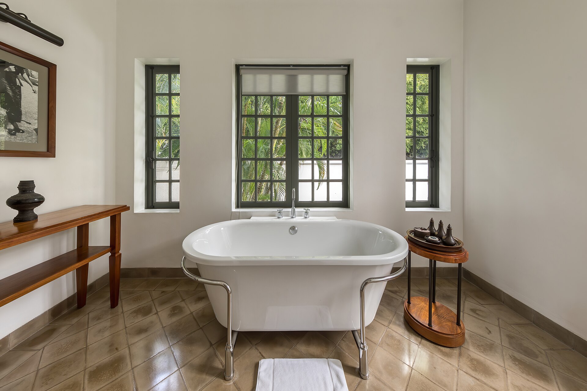 A suite bathroom with a slipper bath and walk-in shower at the Stanley & Livingstone Boutique Hotel