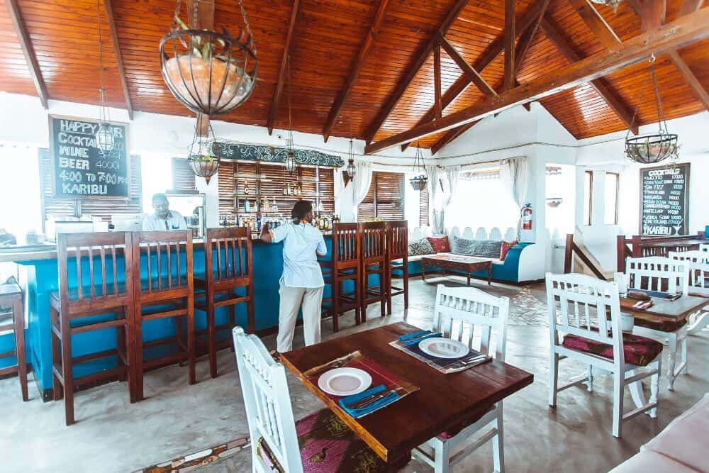 The rooftop restaurant under a thatched roof at The Swahili House, Stone Town