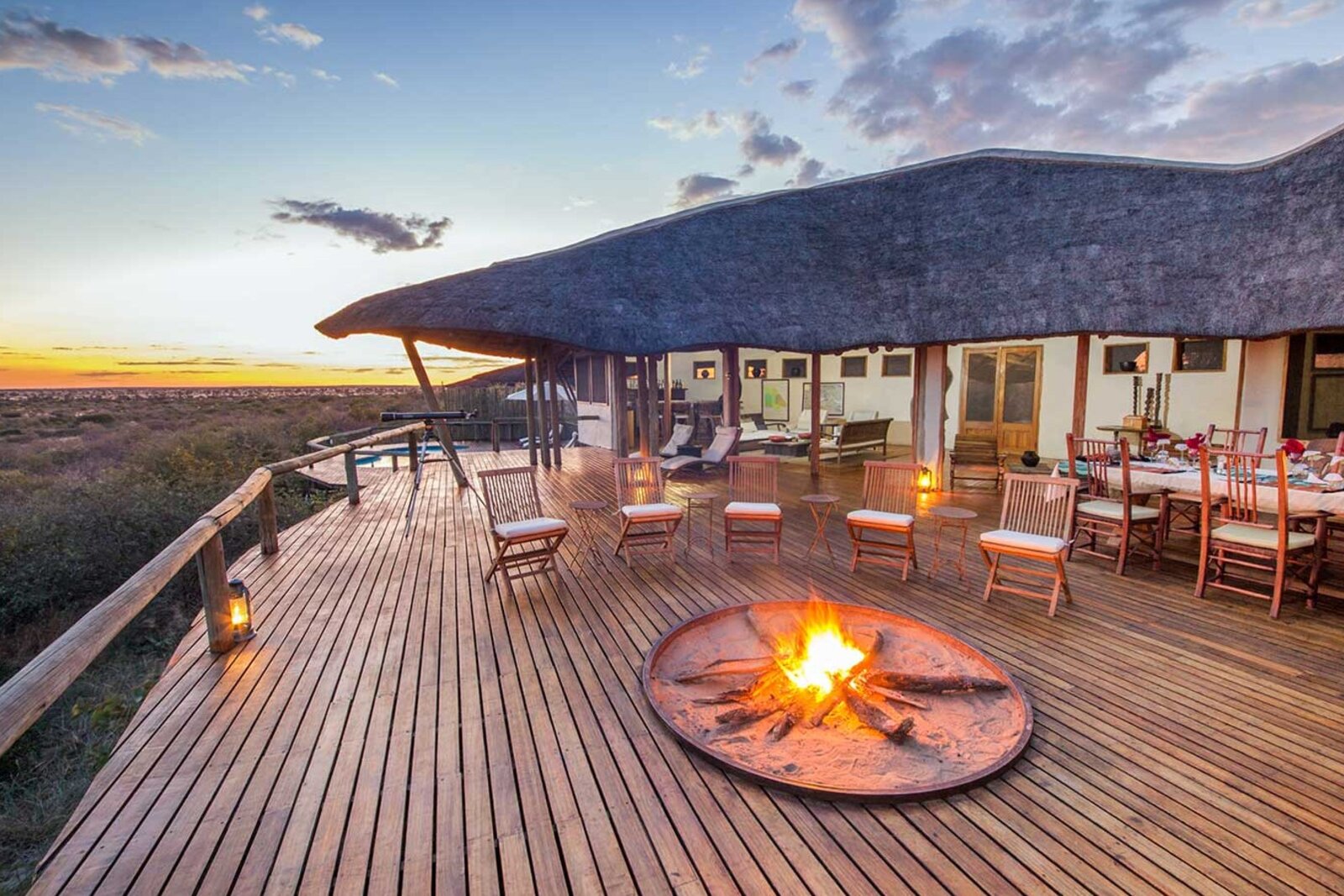 Raised main deck of Tau Pan Camp over the pan at golden hour, Central Kalahari