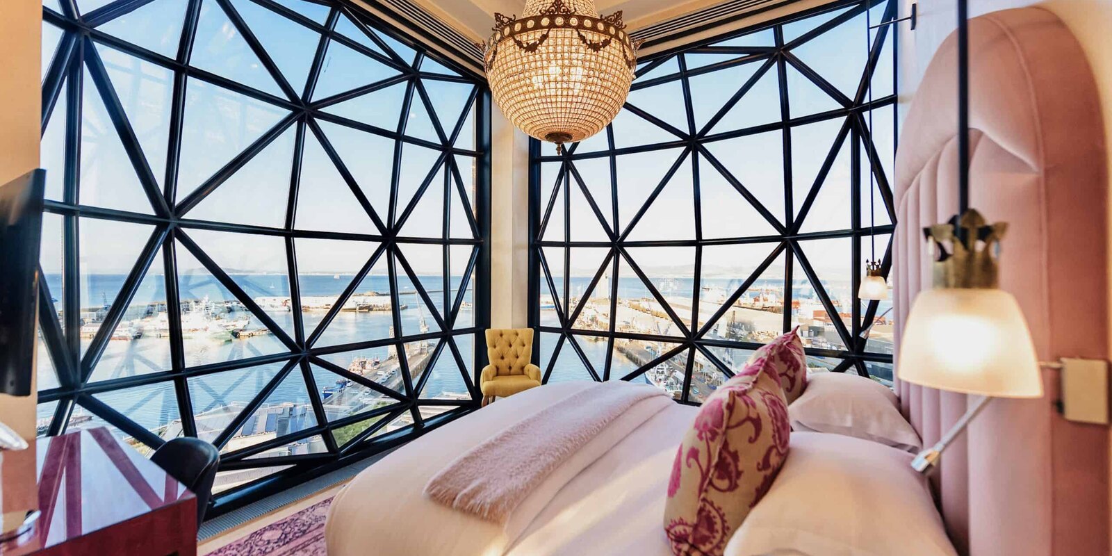 A bedroom at The Silo with a pillowed-glass window looking onto Table Mountain and the city