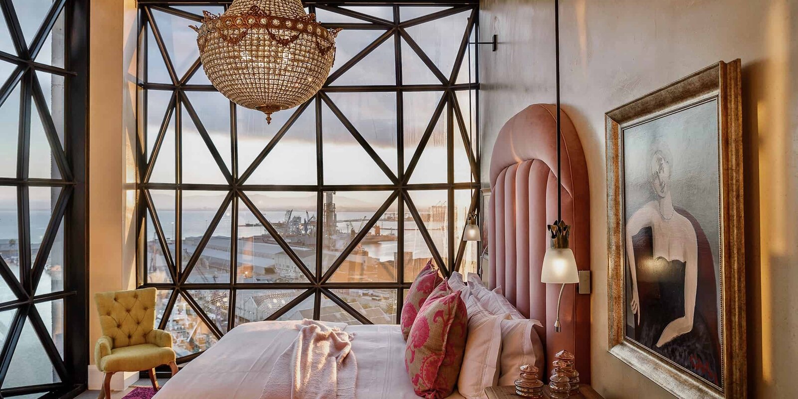 A Royal Suite bedroom at The Silo Hotel with a chandelier and faceted window