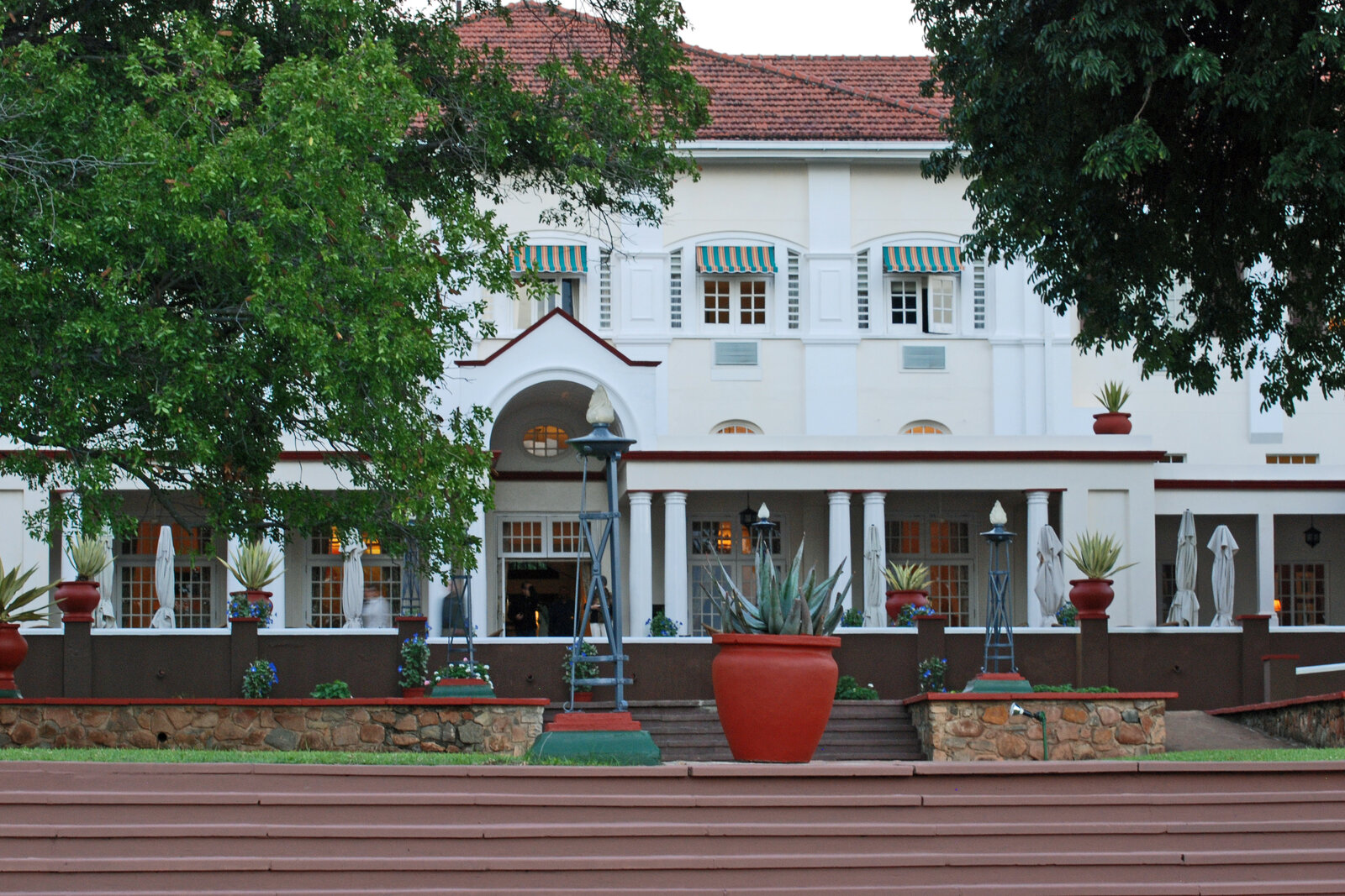 The garden facade of The Victoria Falls Hotel, with its terrace and colonial awnings