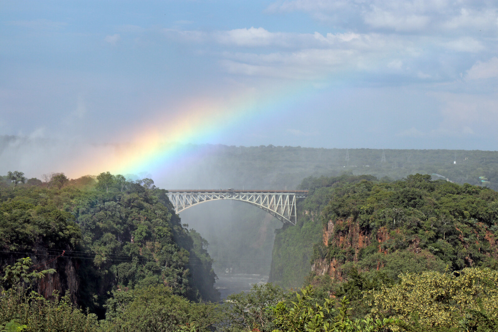 The Victoria Falls Bridge framed from the gardens of The Victoria Falls Hotel