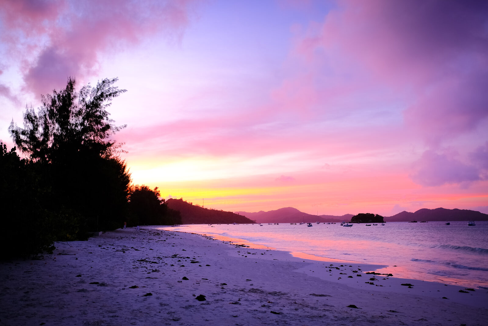 Golden sunset over the sea from a granite beach in the Seychelles