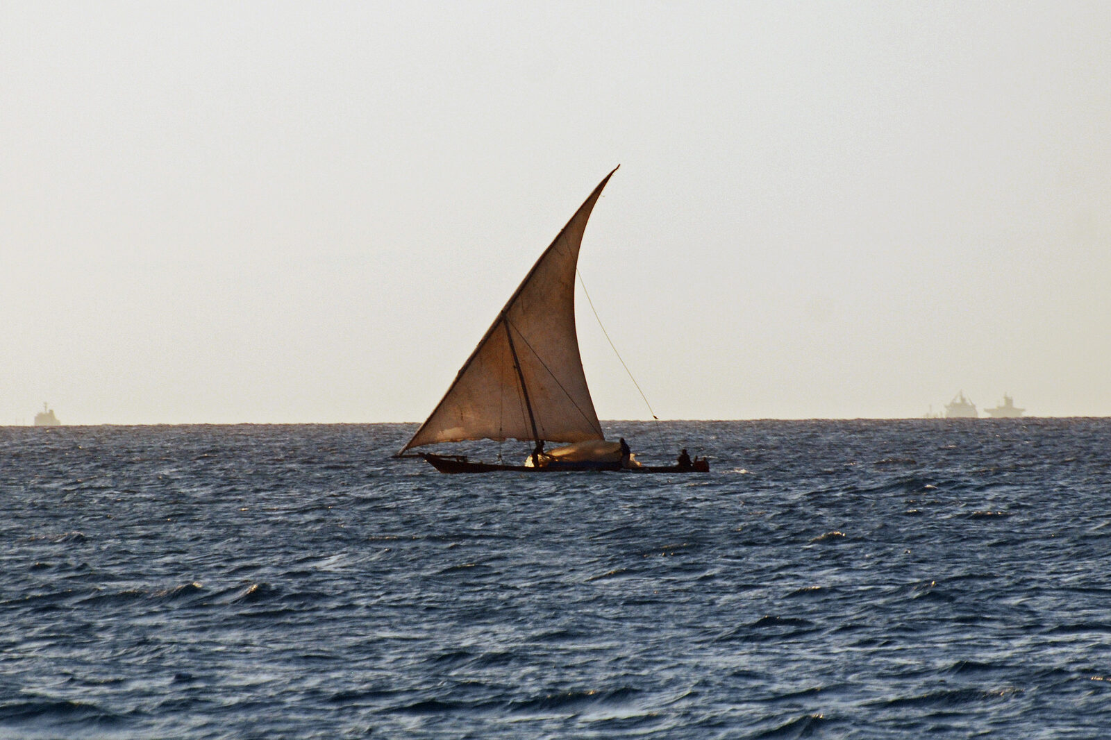 A dhow sailing at golden sunset off Zanzibar