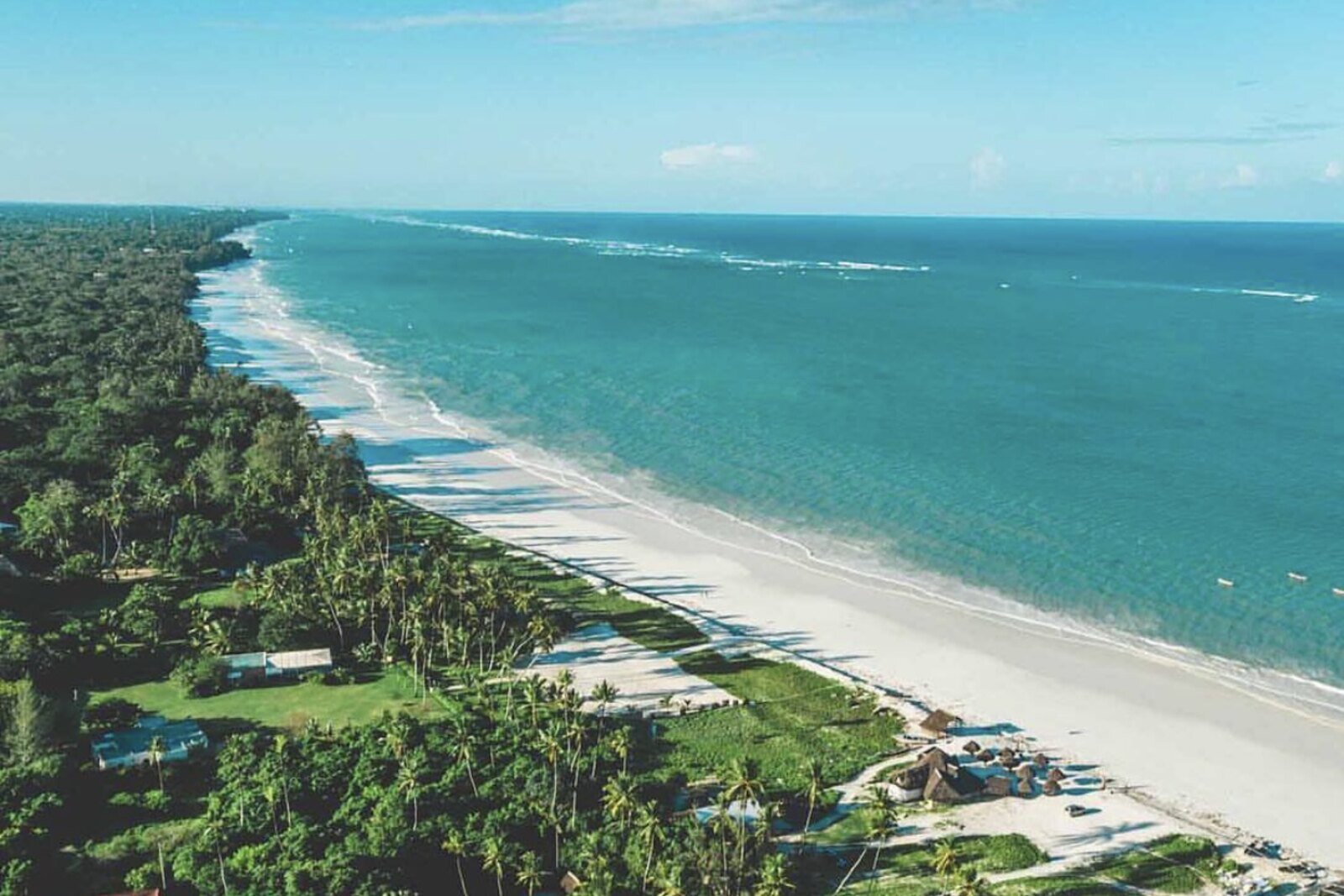 An aerial view of the white sand and turquoise water of Diani Beach