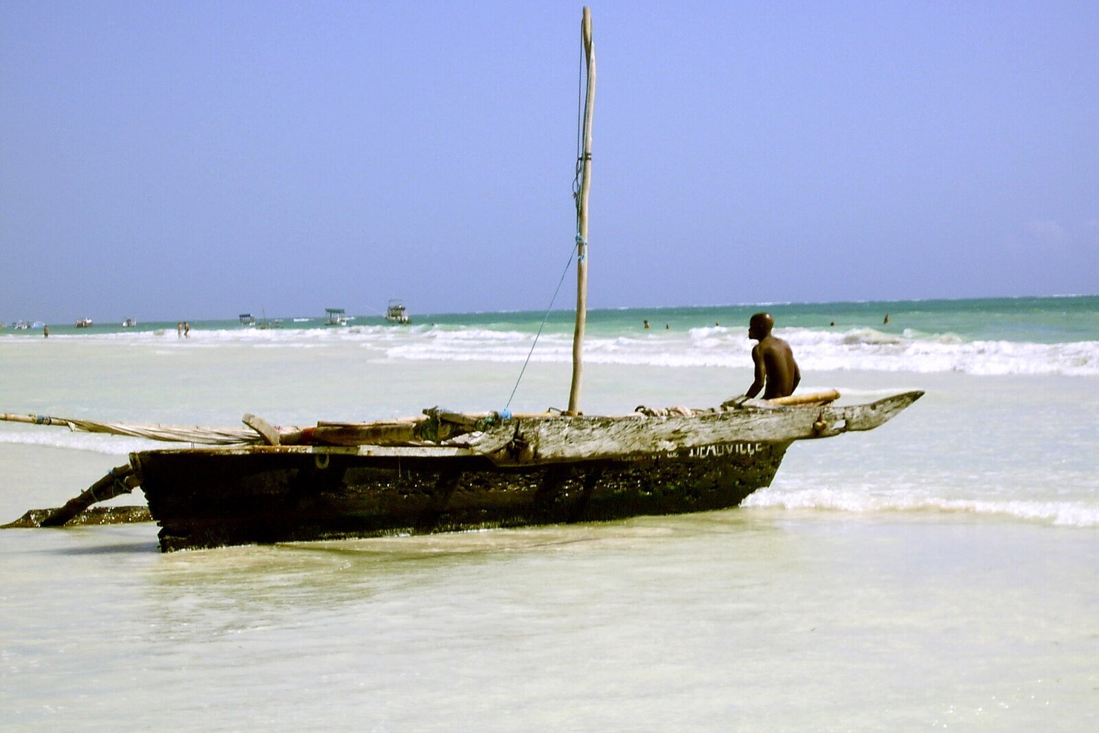 A traditional dhow on a turquoise lagoon on the Kenyan coast