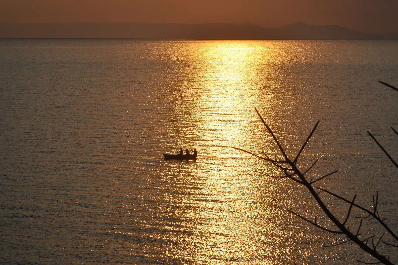 A fiery sunset over the calm waters of Lake Malawi