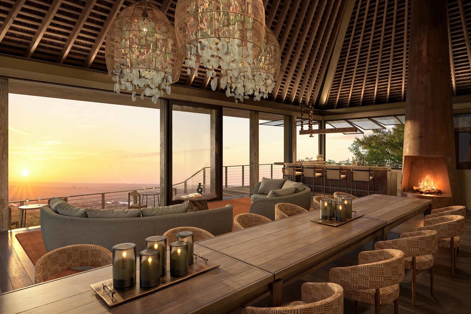 Main lodge dining and lounge at sunset with chandelier and fireplace