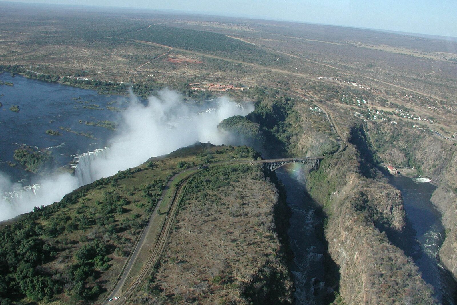 Victoria Falls seen from the air with spray rising from the gorge
