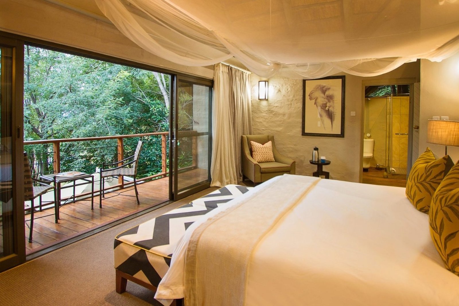 The upstairs Master Gallery Bedroom en-suite with a private balcony view at Victoria Falls Safari Suites