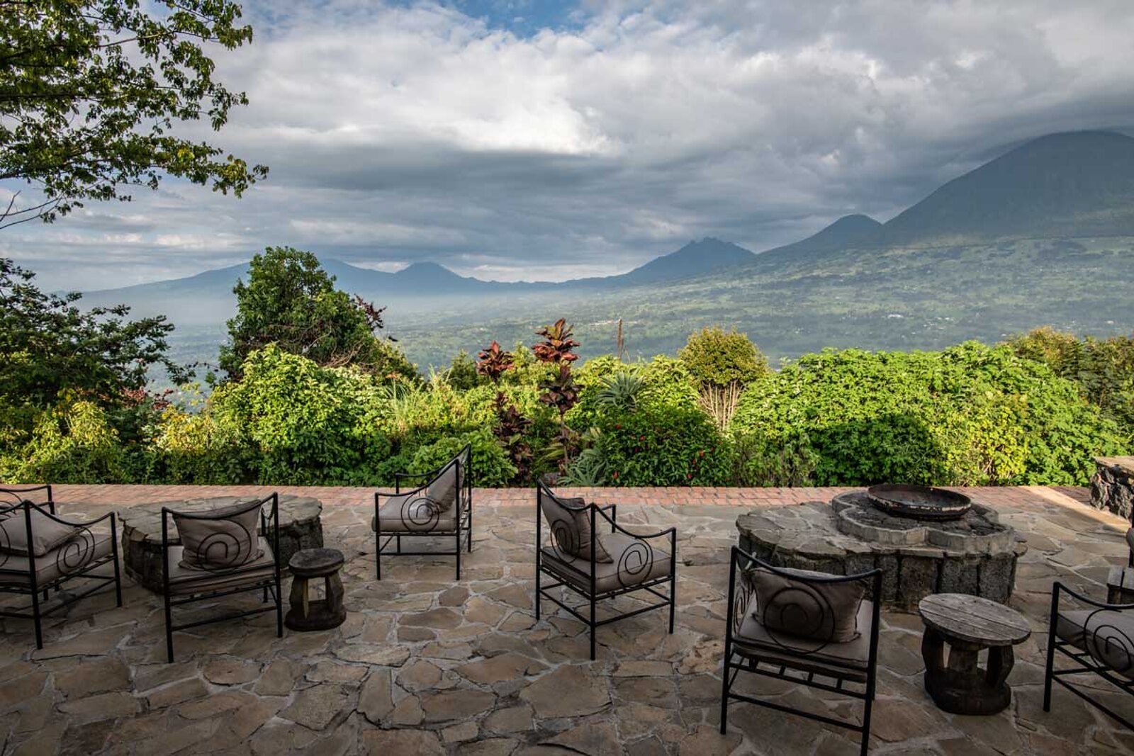Virunga Lodge terrace with a panorama of the Virunga volcanoes and twin lakes at sunset, Rwanda