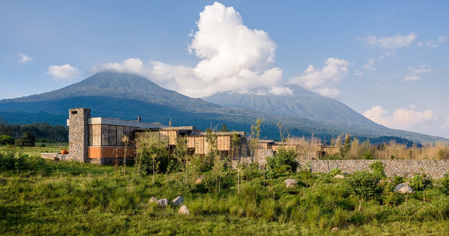 A volcanic-stone luxury suite with views to the Virunga volcanoes