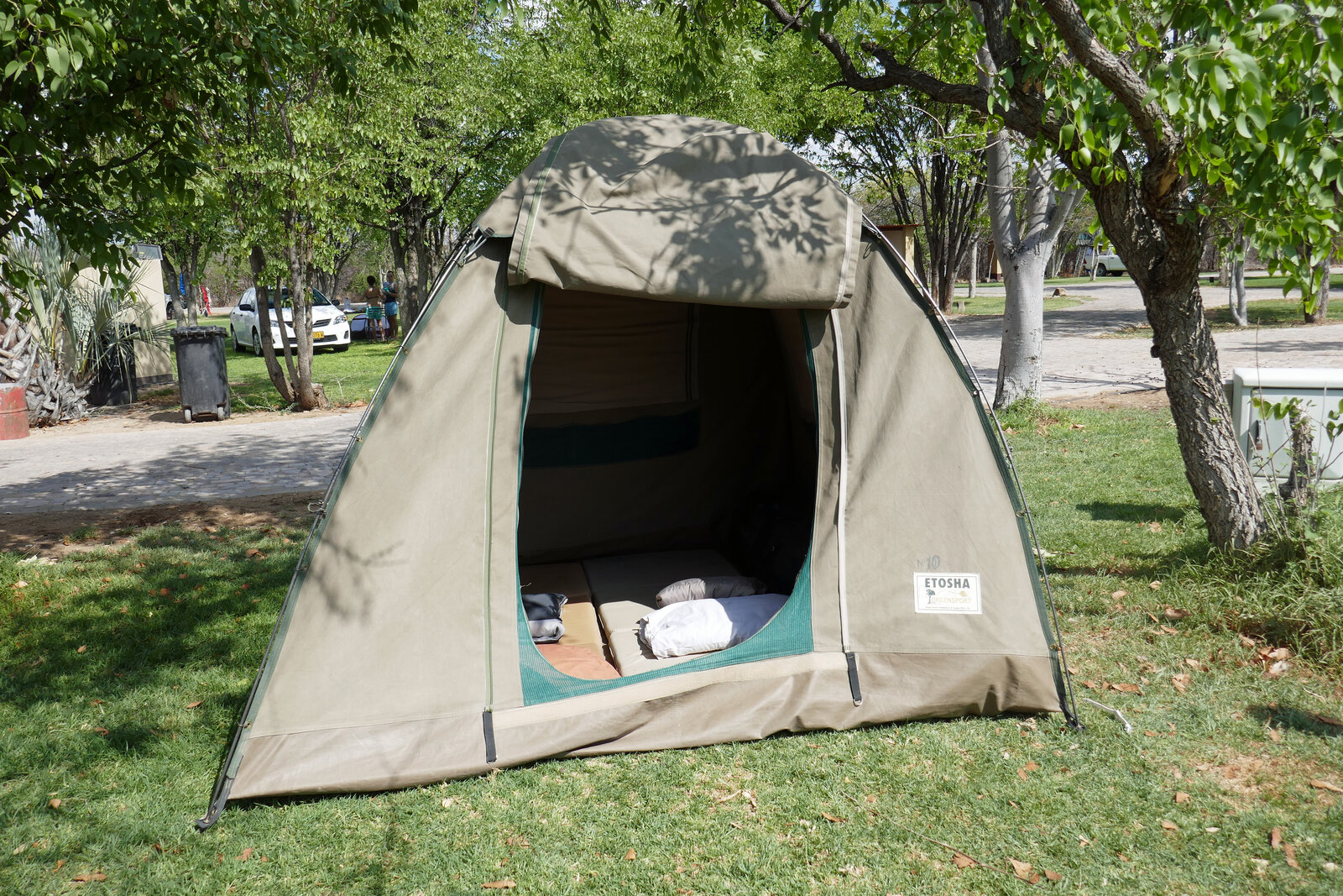 An open dome tent with gear laid out inside