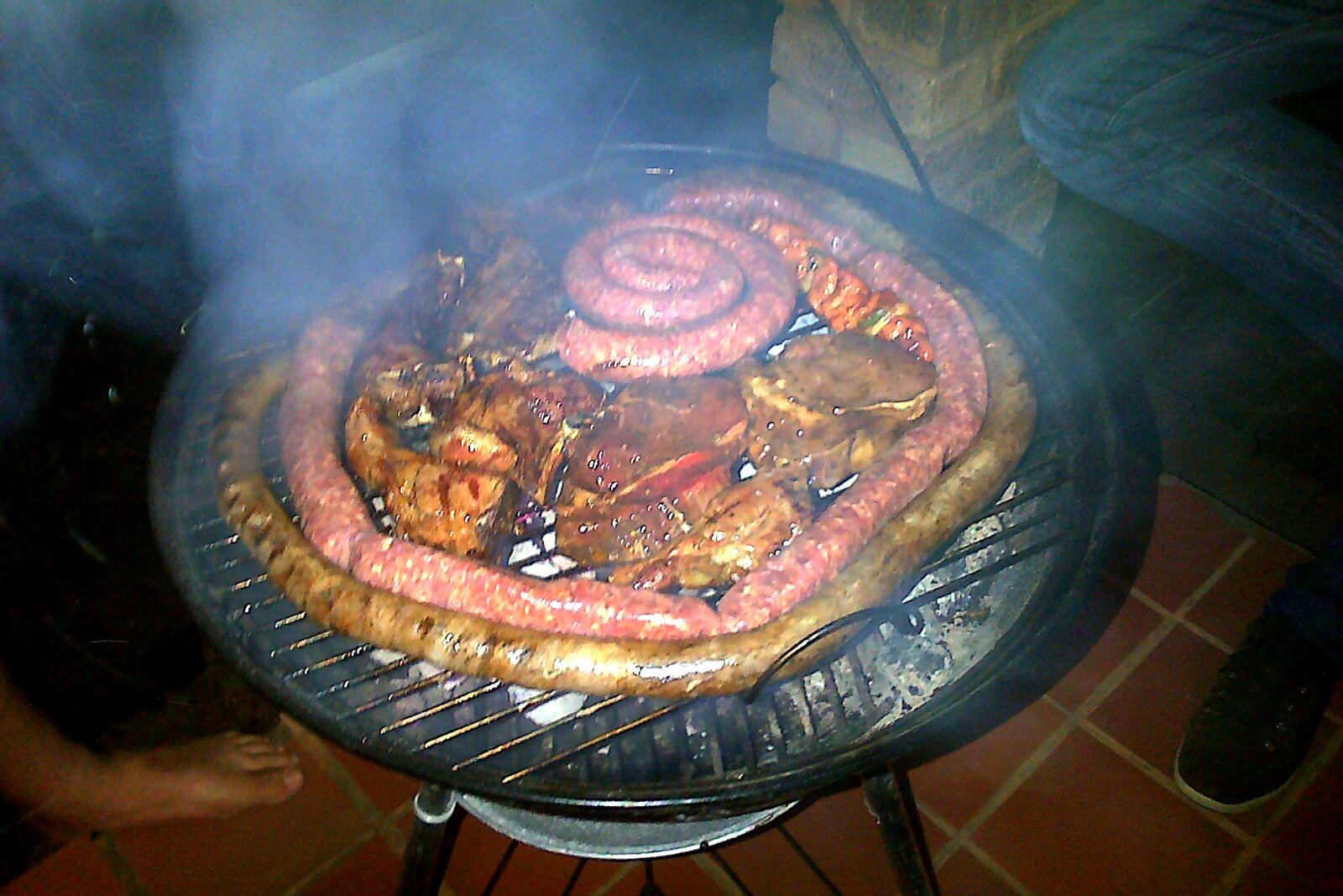 Boerewors sausage sizzling on a South African braai over the coals