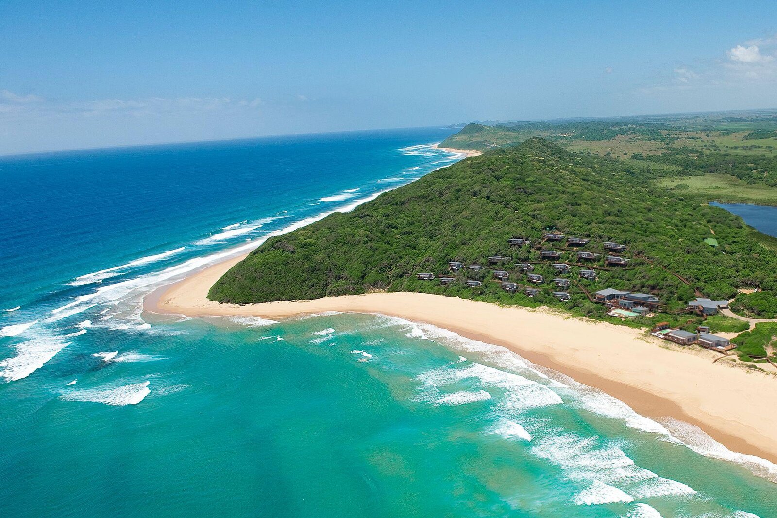 Aerial view of the wild empty dune coastline at White Pearl Ponta Mamoli, southern Mozambique