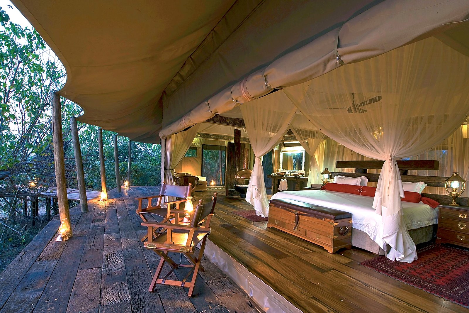Private deck of a Zarafa Camp suite at dusk, overlooking the Selinda wilderness
