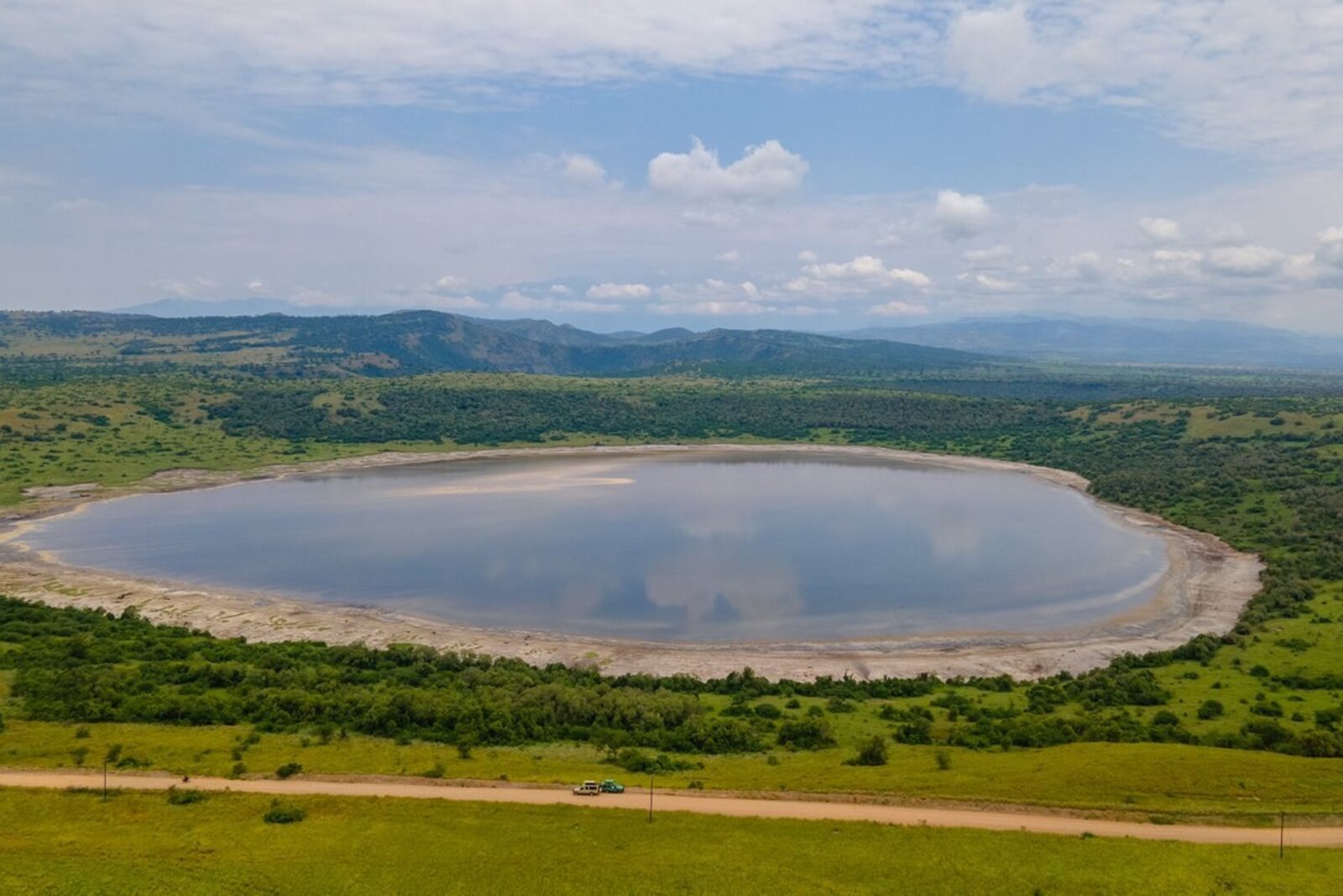 Aerial view of a Hwange National Park waterhole surrounded by wildlife, Zimbabwe