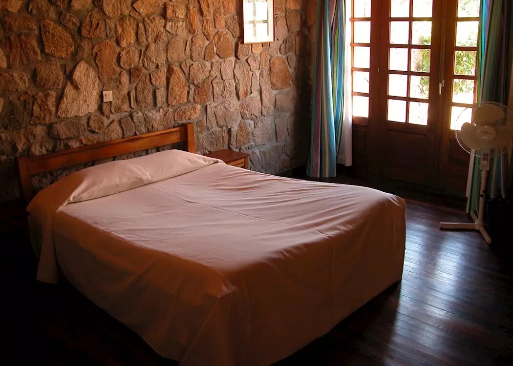 Room with stone walls and timber floor at Le Relais de la Reine, Isalo