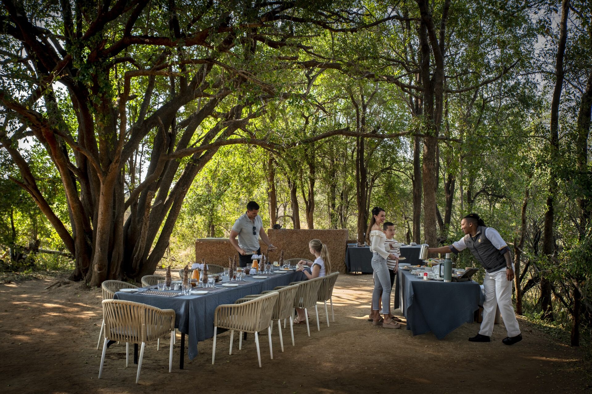 A private bush breakfast laid out beneath shady trees at Morukuru Family Madikwe, deep in the malaria-free Madikwe Game Reserve