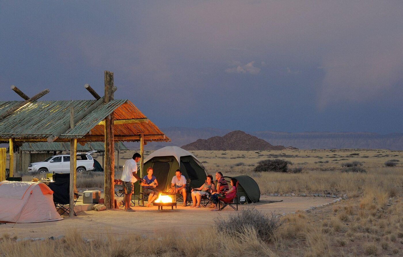 Communal fire and desert setting at Sossus Oasis Campsite, Sesriem