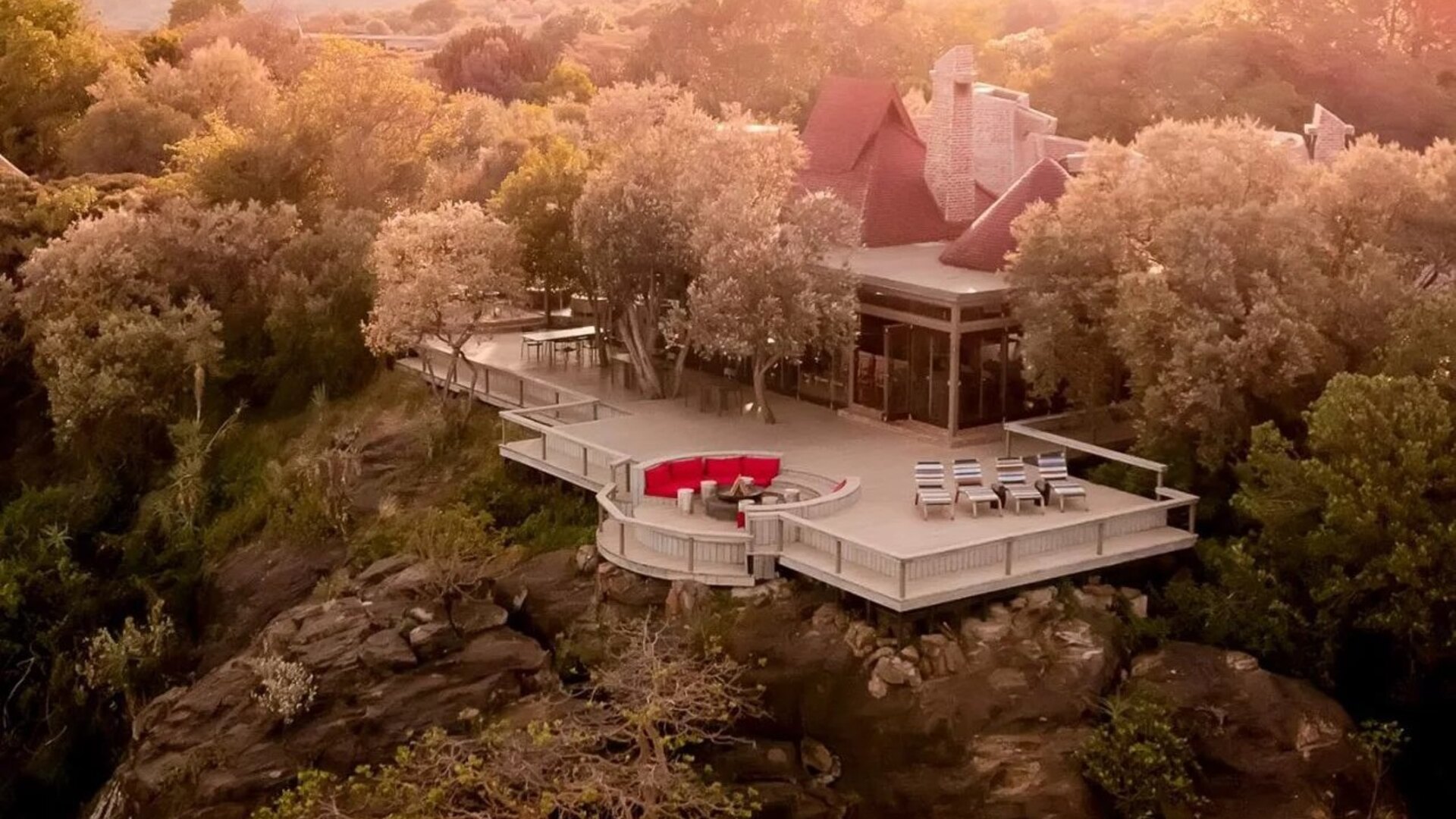Angama Mara's guest suites perched on the edge of the Oloololo Escarpment above the Maasai Mara at golden hour