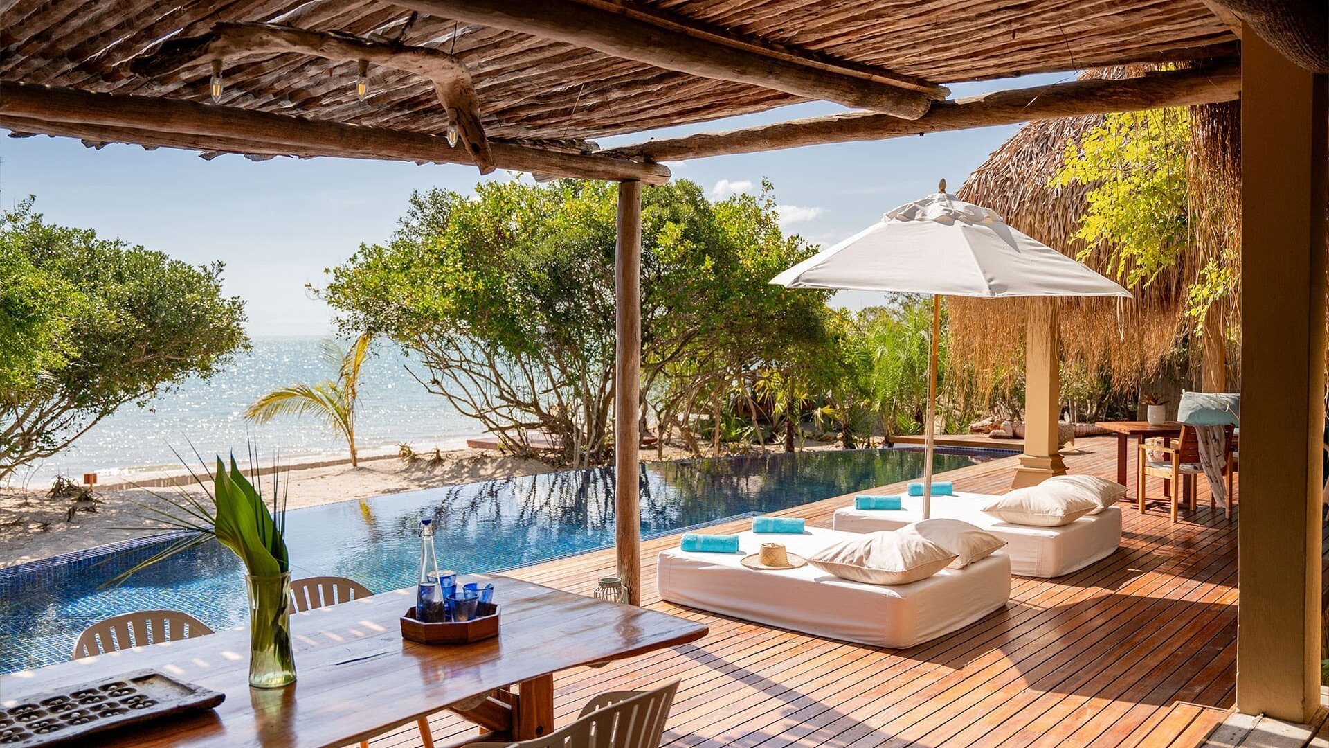 An Azura Benguerra beach villa with a private plunge pool and daybed looking over the turquoise Indian Ocean, Bazaruto Archipelago, Mozambique