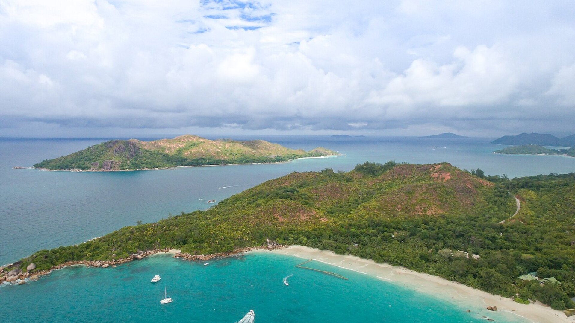 Aerial view of a turquoise lagoon and luxury resort island in Seychelles