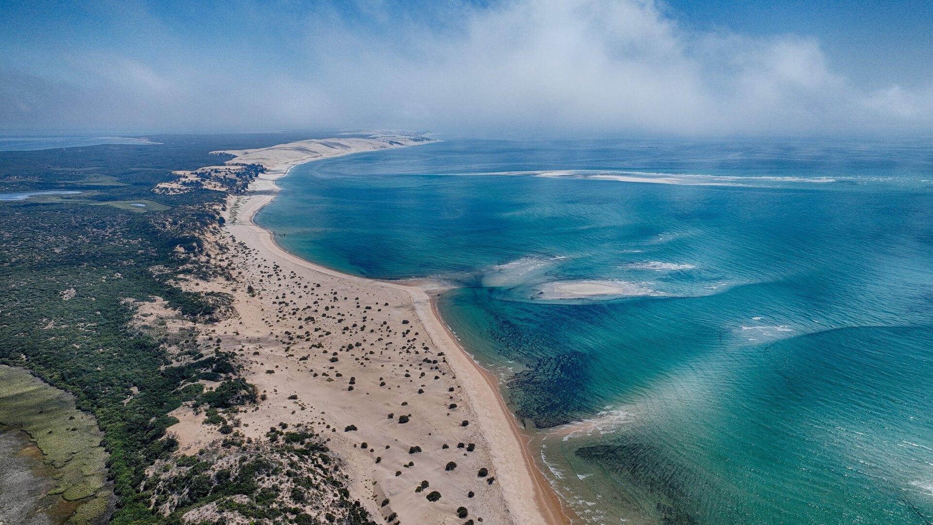 Aerial view of the turquoise shallows, pale sandbanks and dune-forested islands of the Bazaruto Archipelago, Mozambique