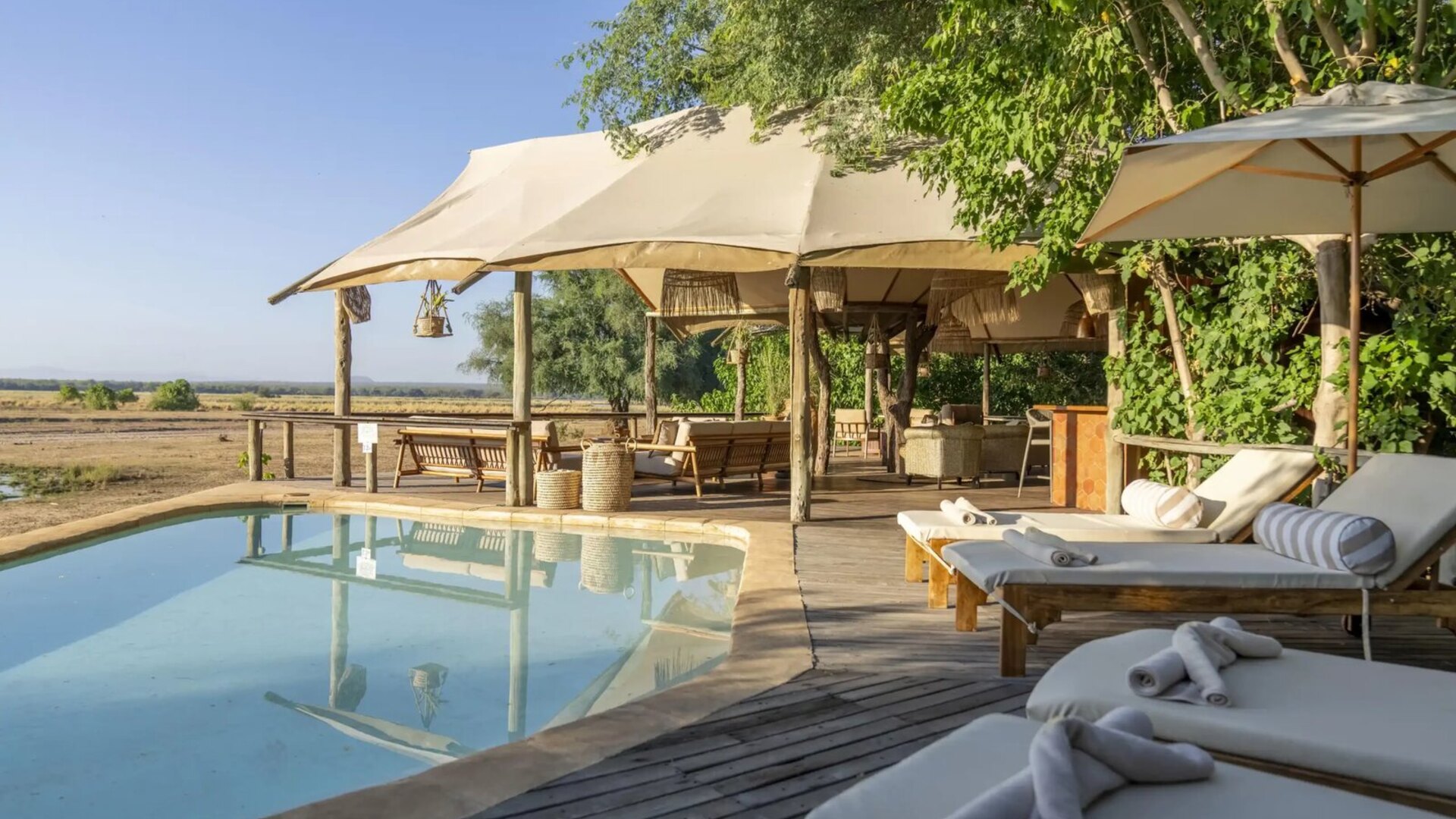 A private safari villa with a deck and pool overlooking the bush, set up for a family