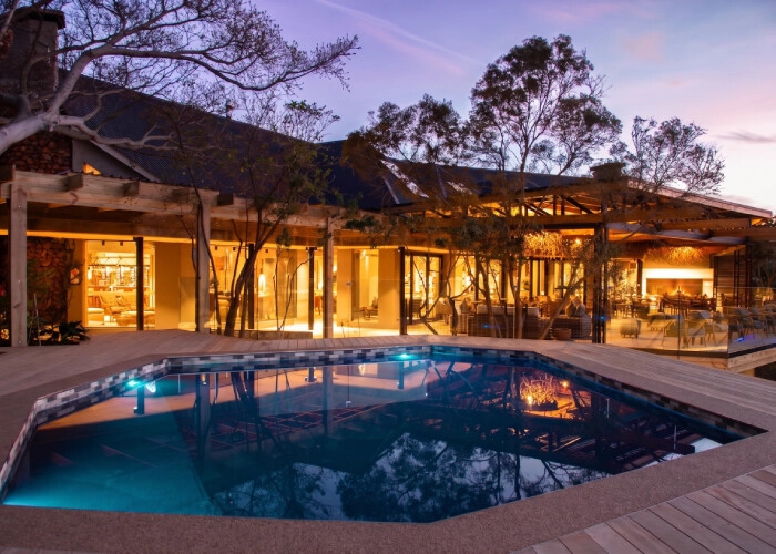 Botlierskop Tented Lodge pool deck at sunset with Outeniqua Mountain views
